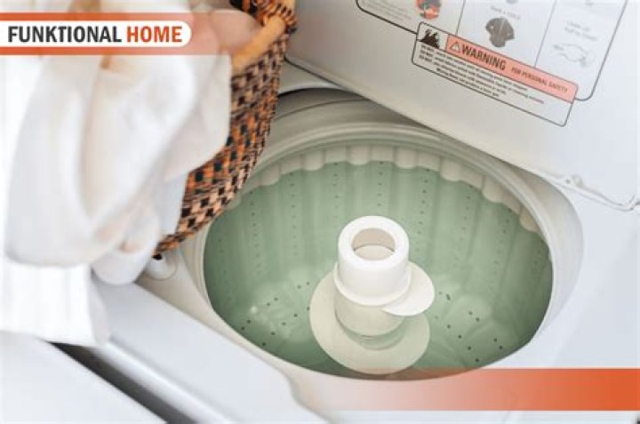 How do I get rid of the smell in my top load washing machine?