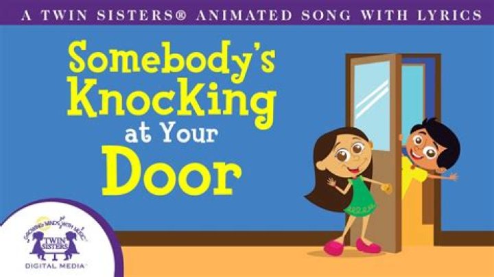 How do I train my dog to bark when someone knocks on the door?