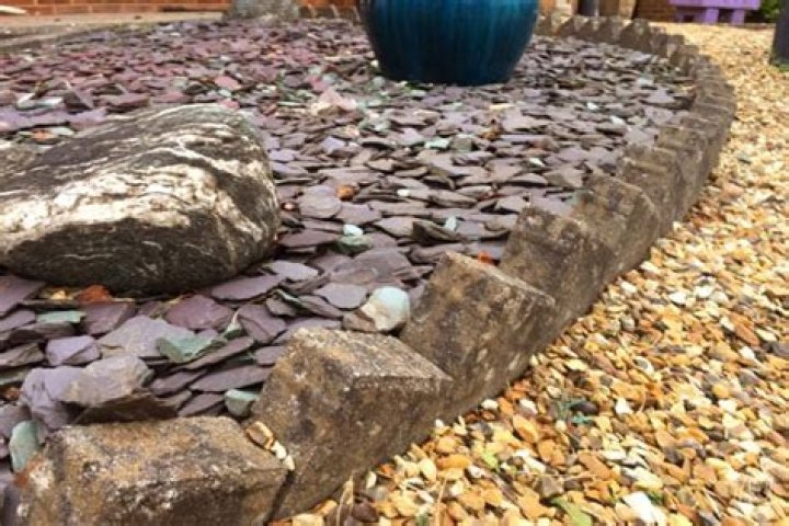 How do you edge a flower bed with stone?