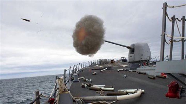 How far can a 5 inch naval gun fire?