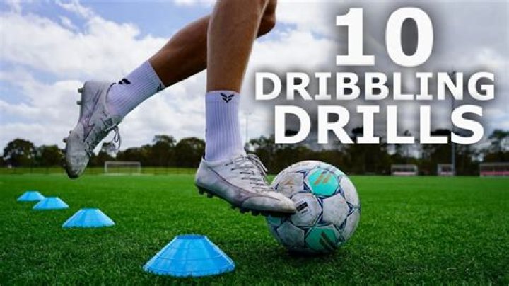 What is dribbling the ball in soccer?