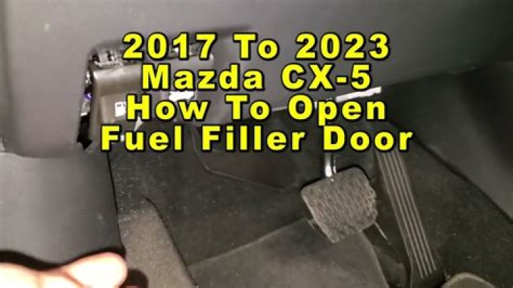 Where is the fuel door release switch located?