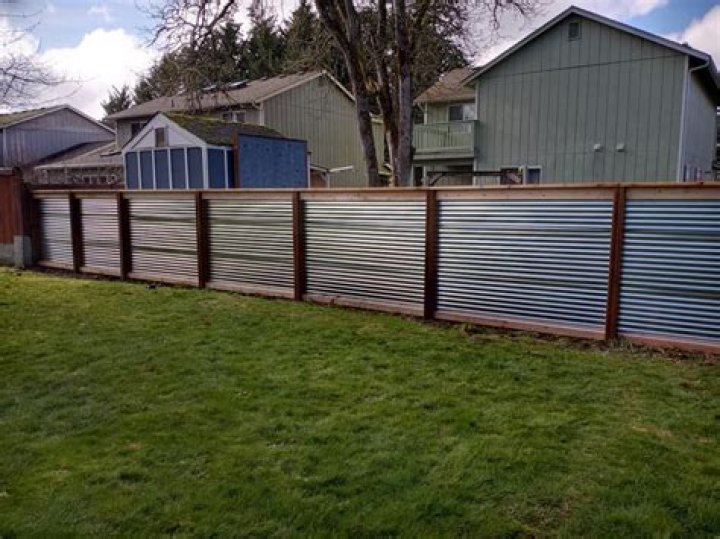 Which is cheaper wood or metal fence?