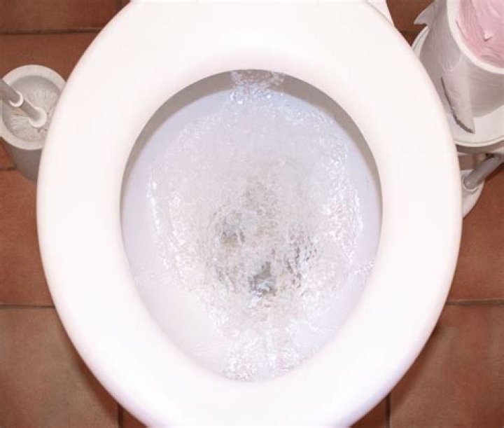 Why is my downstairs toilet bubbling when I flush the upstairs toilet?
